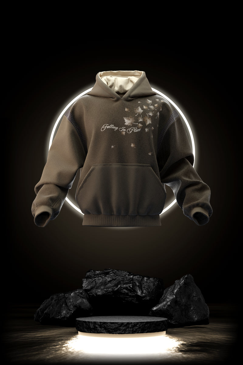 Hoodie with autumn leaves on it, reads 'Falling in place'